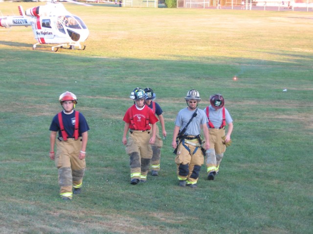 The Engine crew returning from loading a patient into a helicopter.